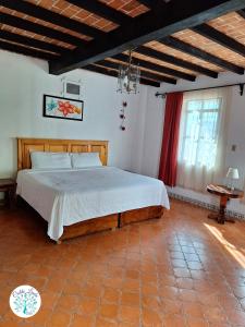 a bedroom with a large bed in a room at Hotel Cielito Lindo, Taxco in Taxco de Alarcón +26 photos