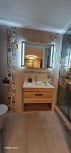 a bathroom with a sink and a mirror at Hébergement Privé à Larnod in Larnod +11 photos