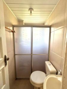 a bathroom with a shower with a toilet and a sink at Apartamento CONFORT 2Q in Rio Branco +3 photos