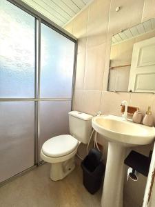 a bathroom with a toilet and a sink at Apartamento CONFORT 2Q in Rio Branco