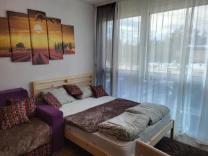 a bedroom with a bed and a window at Studio Lola Jezero in Divčibare