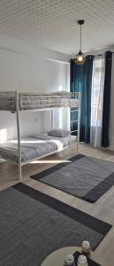 a bedroom with two bunk beds and a rug at Blue T in Saint-Claude