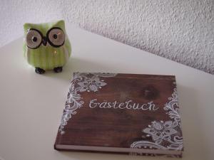 an owl sitting next to a sign on a shelf at Apartment Harzgrün by Interhome in Sankt Andreasberg