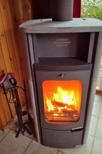 a stove with a fire inside of it at Holiday Home Lea by Interhome in Bremke