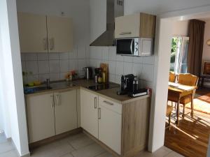 a kitchen with a sink and a microwave at Apartment Rheintalblick 2 by Interhome in Linz am Rhein +2 photos