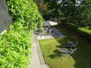 a group of chairs and tables in a yard at Apartment Rheintalblick 2 by Interhome in Linz am Rhein