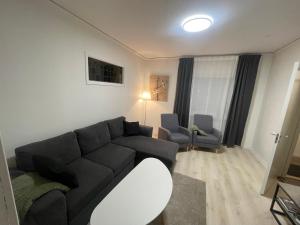 a living room with a couch and two chairs at Prisvärd & rymlig lgh nära ALV in Vimmerby
