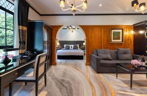 a living room with a bed and a couch at Hana Lodge in Rotorua
