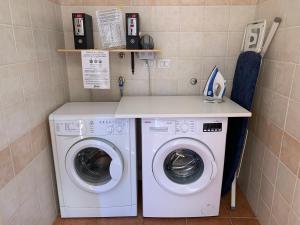 a laundry room with a washer and dryer at Agriturismo Barattis in Piombino