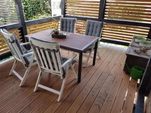 a wooden table and four chairs on a deck at Apartment Mia by Interhome in Fritzlar