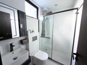 a bathroom with a shower and a toilet and a sink at Reagal Garden in Hulhumale +27 photos