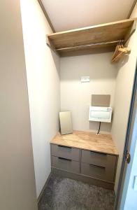 a small room with a desk with a computer in it at Parkside Retreats in Kirby Misperton