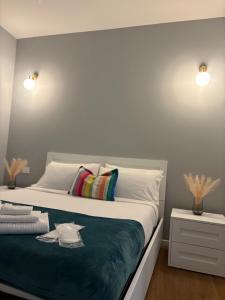a bedroom with a large white bed with a blue blanket at AB apartment Pistoia in Pistoia +28 photos