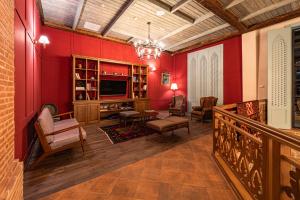a living room with red walls and a television at Agarani Estate in Telavi