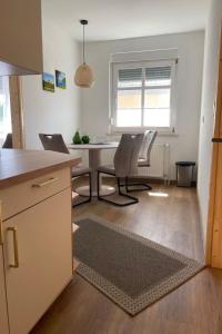 a kitchen and dining room with a table and chairs at Apartment Fewo Wilhelm by Interhome in Scholis +10 photos