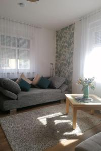 a living room with a couch and a table at Apartment Fewo Wilhelm by Interhome in Scholis