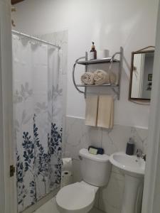 a bathroom with a toilet and a sink at EL sunzal Bliss #8 in El Sunzal +7 photos
