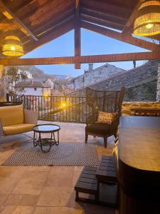 a patio with chairs and a table on a balcony at Maison de charme - Le Palha in Blesle +14 photos