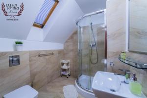 a bathroom with a shower and a sink at Willa Atena in Świnoujście