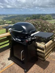 a grill is sitting on top of a table at Pine Holt Cottage in Warkworth