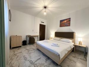 a bedroom with a large white bed in a room at Casa Giulia in Vama Veche +33 photos