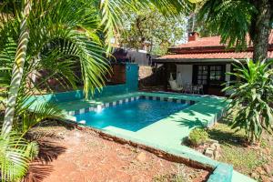 a swimming pool in the yard of a house at Posada de Ana in Puerto Iguazú