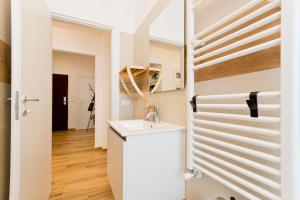 a white bathroom with a sink and a door at Amor Luxury Home in Pescara