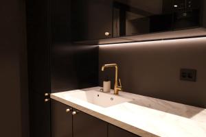 a bathroom with a white sink and a mirror at Arctic City Suites 1 in Kirkenes +17 photos
