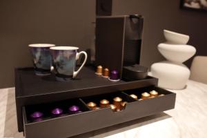 a black box with two cups and some candles at Arctic City Suites 1 in Kirkenes