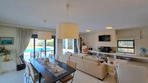 a kitchen and living room with a table and a couch at Seaview Villa Theologos in Theologos