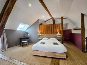 a bedroom with a large bed in a attic at Gite De L'Aeti - Bail Partner in Chablis +19 photos