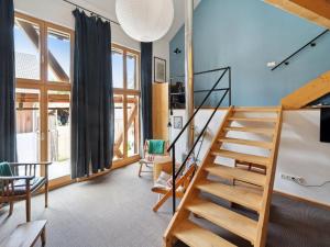 a living room with a staircase and some windows at Apartment Spiegl by Interhome in Waizacker