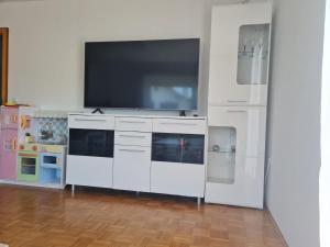 a white entertainment center with a flat screen tv at Apartment Lusen by Interhome in Frauenau