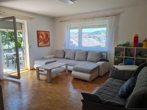 a living room with a couch and a table at Apartment Lusen by Interhome in Frauenau +4 photos