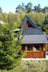 a house with a roof with solar panels on it at Holiday Home Eifelwaldhäuschen by Interhome in Blankenheim +45 photos