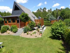 a house with a garden in front of it at Holiday Home Eifelwaldhäuschen by Interhome in Blankenheim