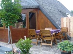 a house with a table and chairs in front of it at Holiday Home Eifelwaldhäuschen by Interhome in Blankenheim