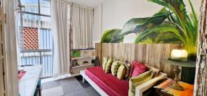 a living room with a couch and a large window at COPSE0102 - Edifício Themis in Salvador