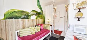 a room with a bench with yellow and pink pillows at COPSE0102 - Edifício Themis in Salvador