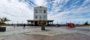 a tall white building with people walking in front of it at COPSE0102 - Edifício Themis in Salvador