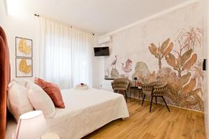 a bedroom with a bed and a table with chairs at Amor Luxury Home in Pescara