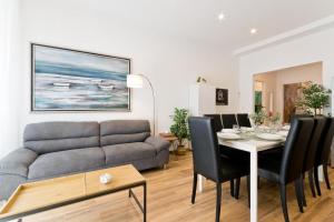 a living room with a couch and a table with chairs at Amor Luxury Home in Pescara