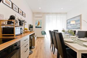 a kitchen and dining room with a table and chairs at Amor Luxury Home in Pescara +17 photos