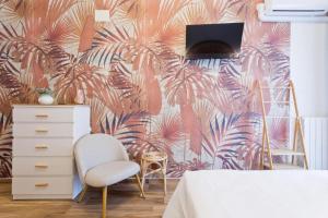 a bedroom with a wall mural of palm trees at Amor Luxury Home in Pescara