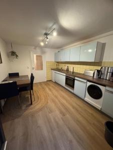 a large kitchen with a table and a dining room at Schöne Wohnung an einer Pferdeweide in Borstel +2 photos