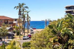 a view of the ocean from a street at The Chelsea Beachside Apartment in The Entrance