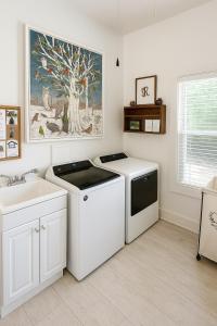 a laundry room with a dishwasher and a sink at Gingerbird Art Suite in Laurel