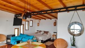 a bedroom with a bed and a table and chairs at Cabañas Refugio Costero in Pelluhue