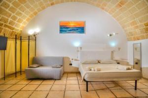 a bedroom with a bed and a couch at History Station in Brindisi