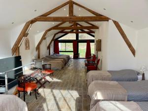a room with a bunch of beds in a building at La Sorga - gîte 12 personnes in Blesle